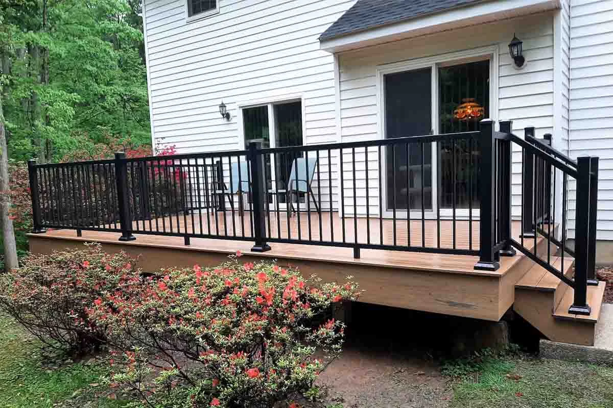 Black deck railing adding a modern stylish look to a backyard