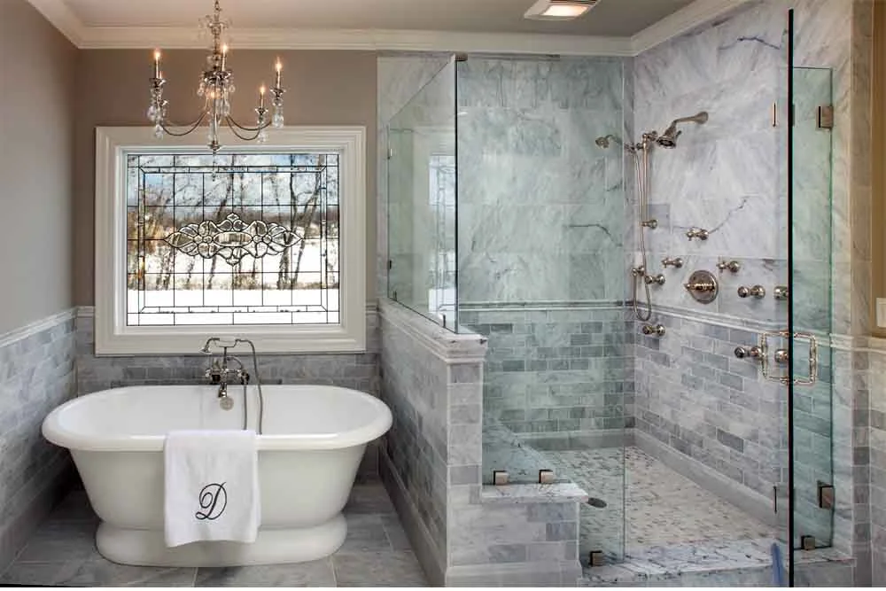 home builders working on a bathroom remodel project with tools and plans